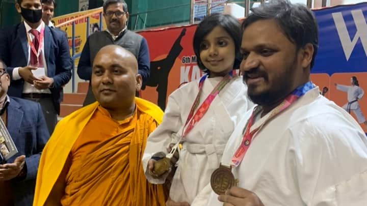 Dr Krishna N Sharma and his daughter Arisha Sharma receiving Gold Medal in All India Open Karate Championship 2022